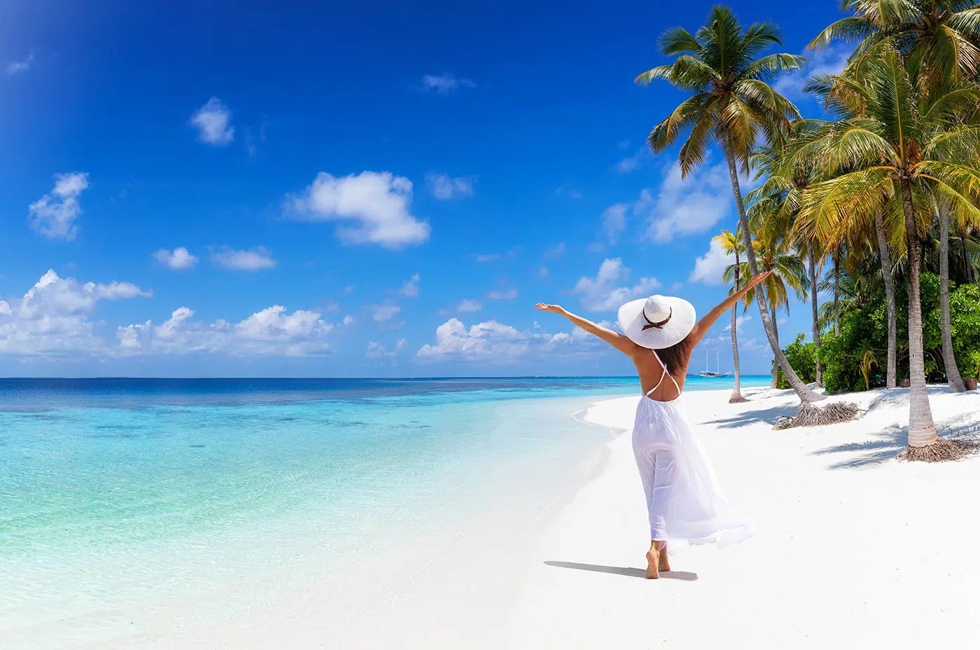 a young woman tourist on the white sandy beach of zanzibar tanzania